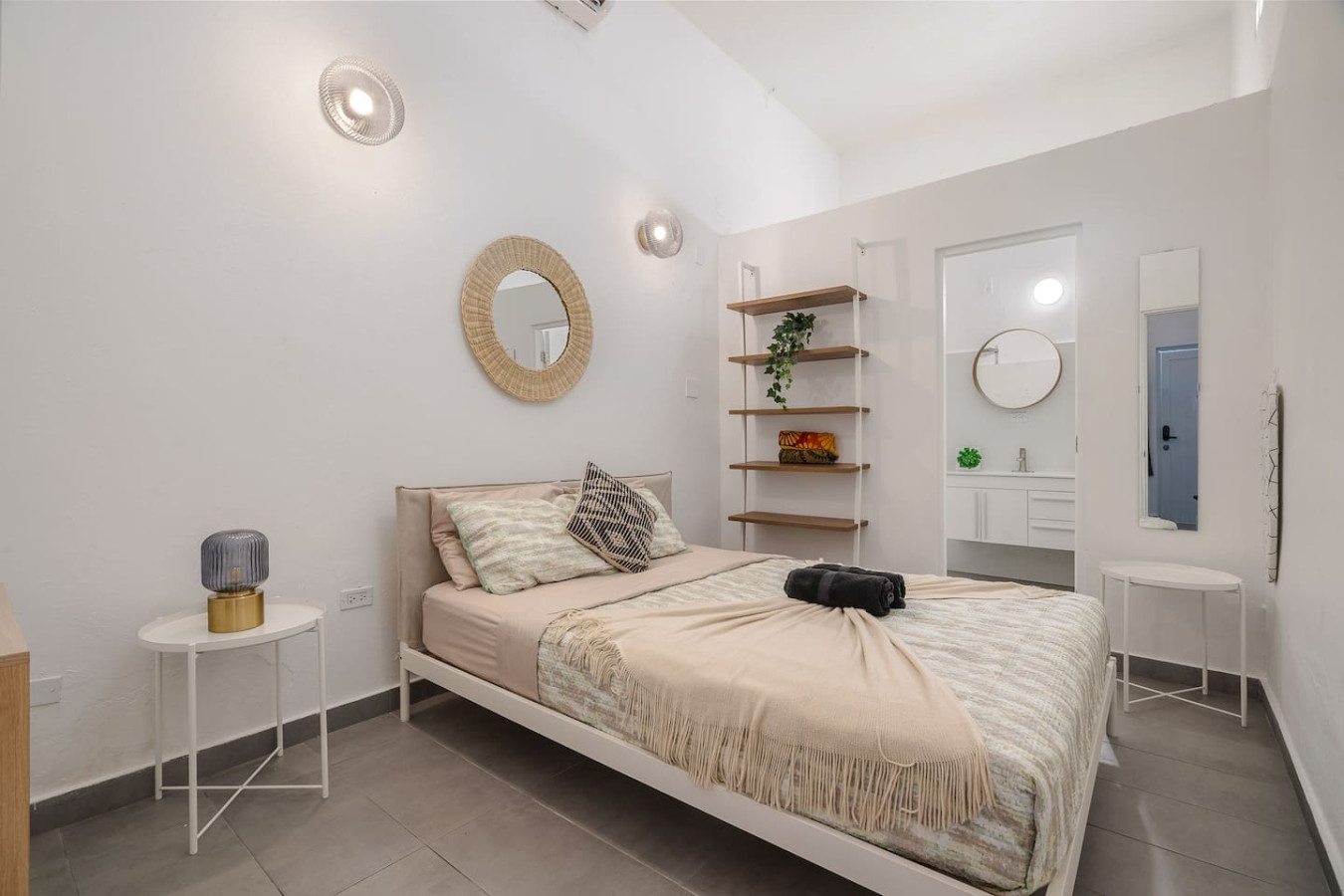 Bedroom with a white bed and a mirror on the wall — Downtown San Juan Gateway Dream, Santurce