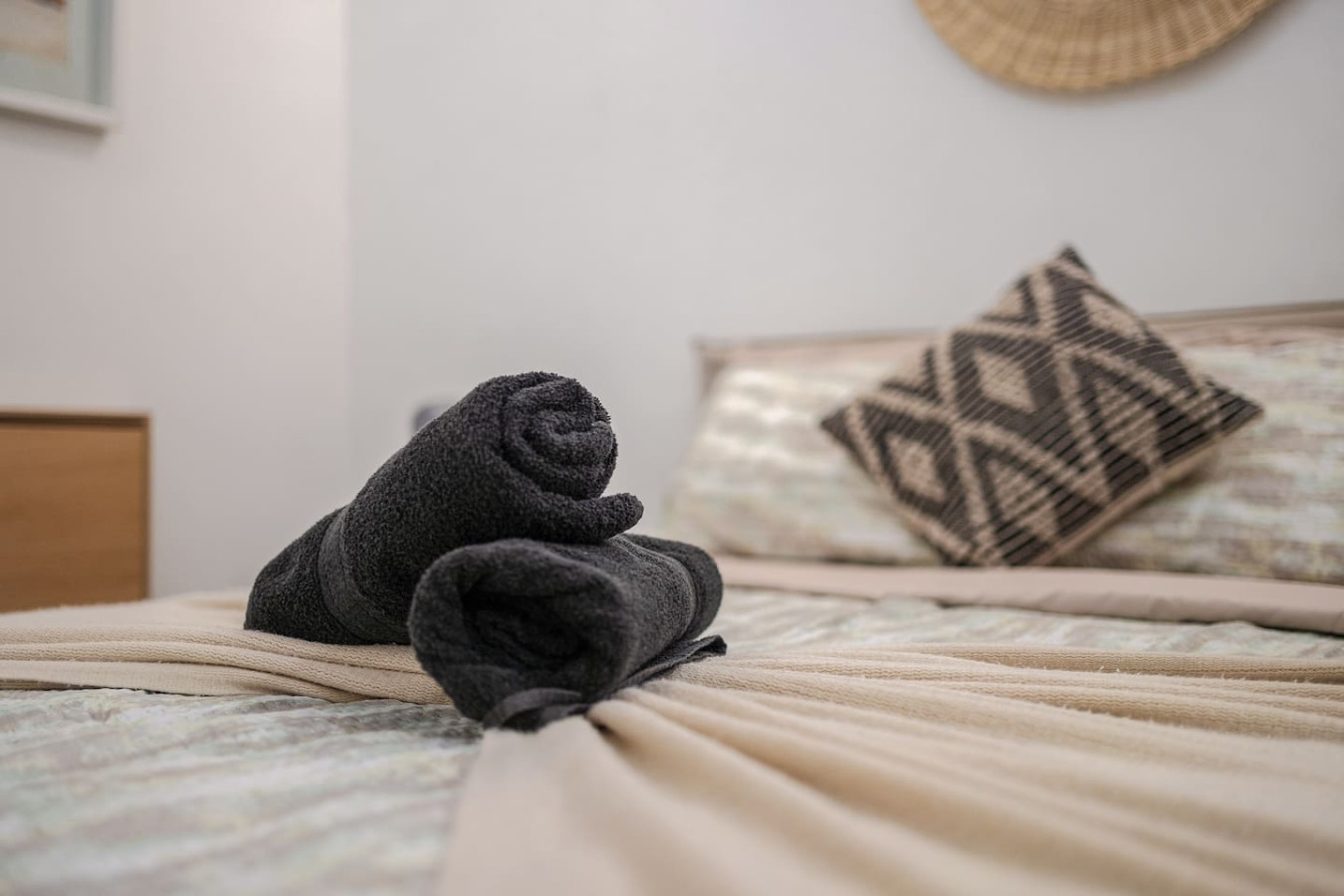 Bedroom with a bed and two towels on it — Downtown San Juan Gateway Dream, Santurce