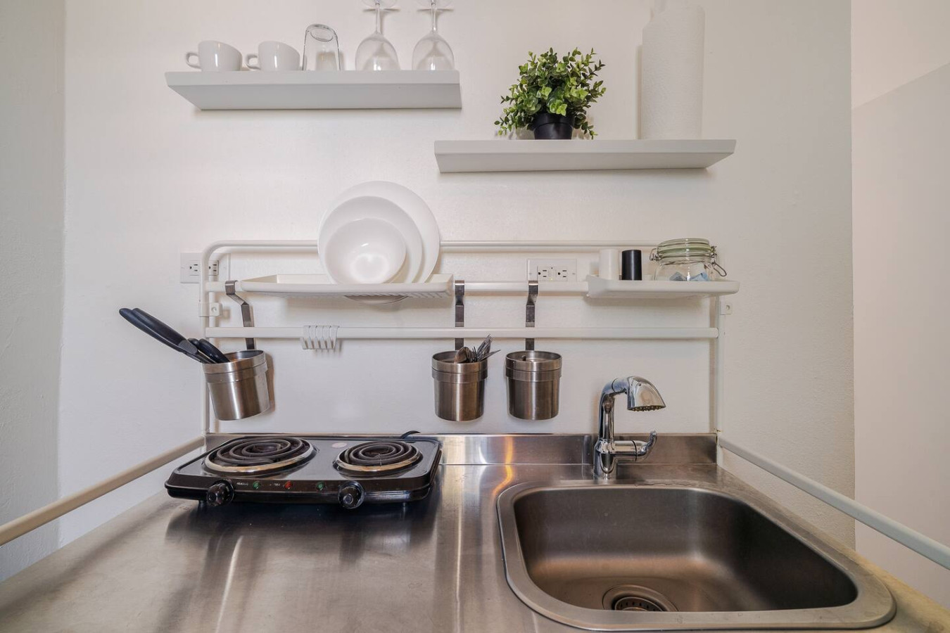 Stainless steel kitchen with a stove top oven and a sink — Downtown San Juan Gateway Dream, Santurce