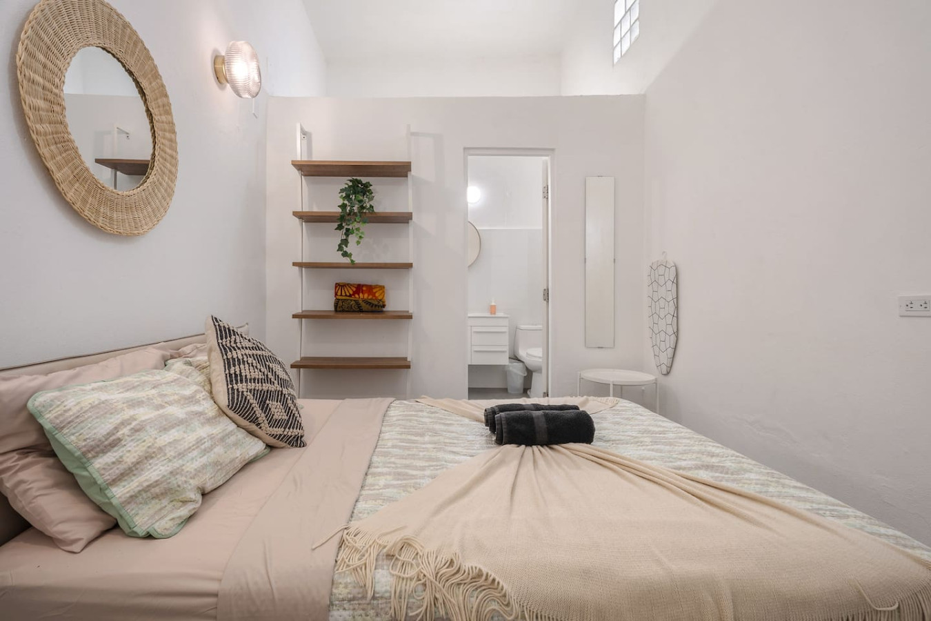Bedroom with a bed, a bookshelf, and a mirror — Downtown San Juan Gateway Dream, Santurce