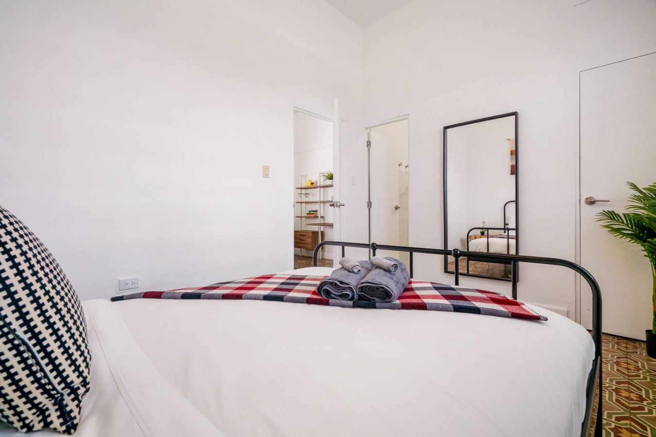 Bedroom with a bed and a mirror (bedroom 2) — Luz Collection No.2 – Casa Brisa | 3BR Retreat, Santurce