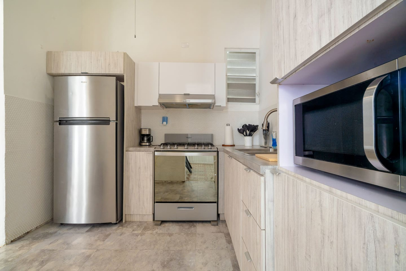 Kitchen with a refrigerator, microwave, and oven — Luz Collection No.2 – Casa Brisa | 3BR Retreat, Santurce