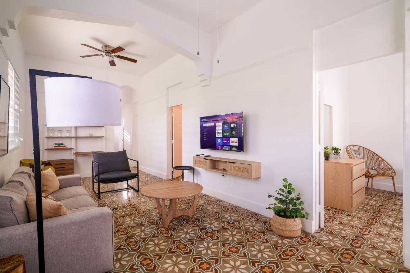 Living room with a flat screen TV and a chair — Luz Collection No.2 – Casa Brisa | 3BR Retreat, Santurce