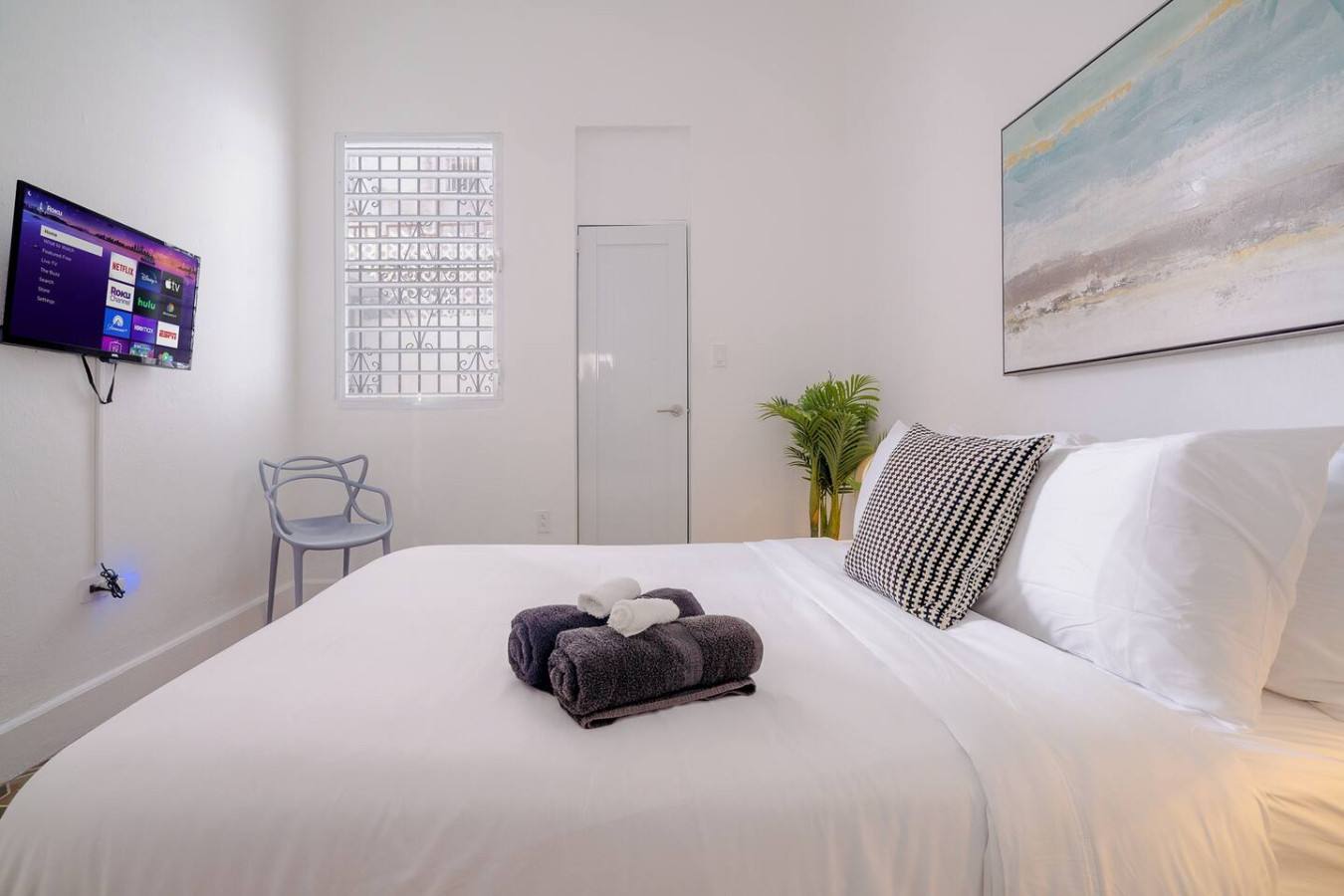 Bedroom with a white bed and a blue chair — Luz Collection No.2 – Casa Brisa | 3BR Retreat, Santurce