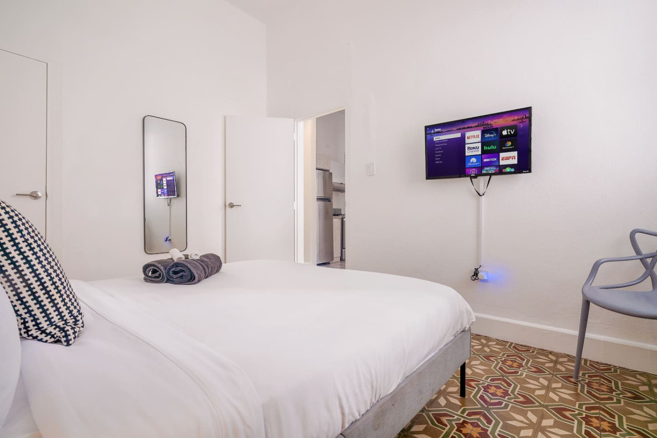 Bedroom with a bed and a mirror — Luz Collection No.2 – Casa Brisa | 3BR Retreat, Santurce