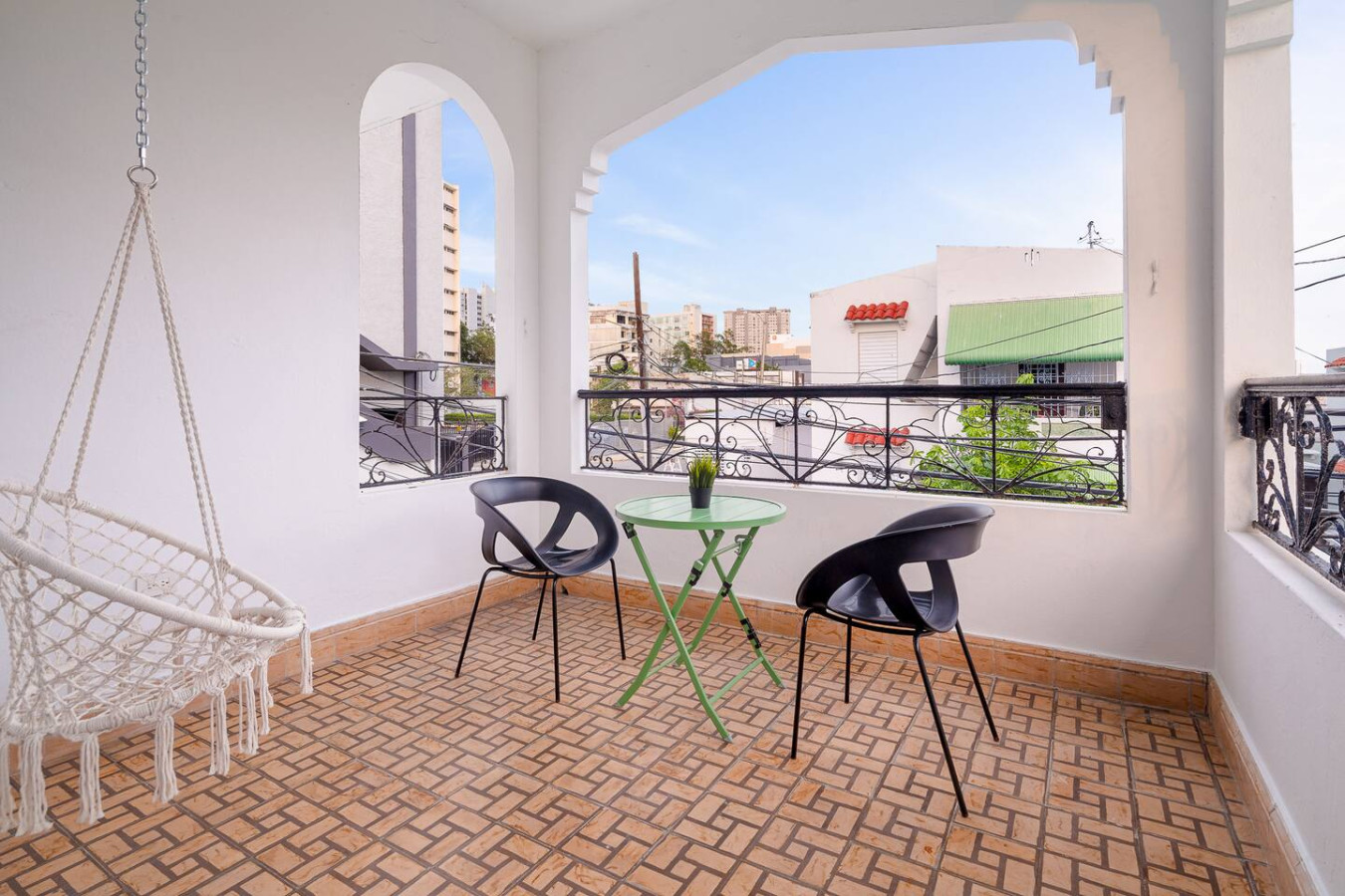 Balcony with two chairs and a table — Luz Collection No.3 – Casa Horizonte | 3BR Loft, Santurce
