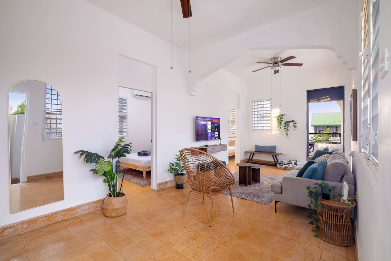 Living room with a TV and a potted plant — Luz Collection No.3 – Casa Horizonte | 3BR Loft, Santurce