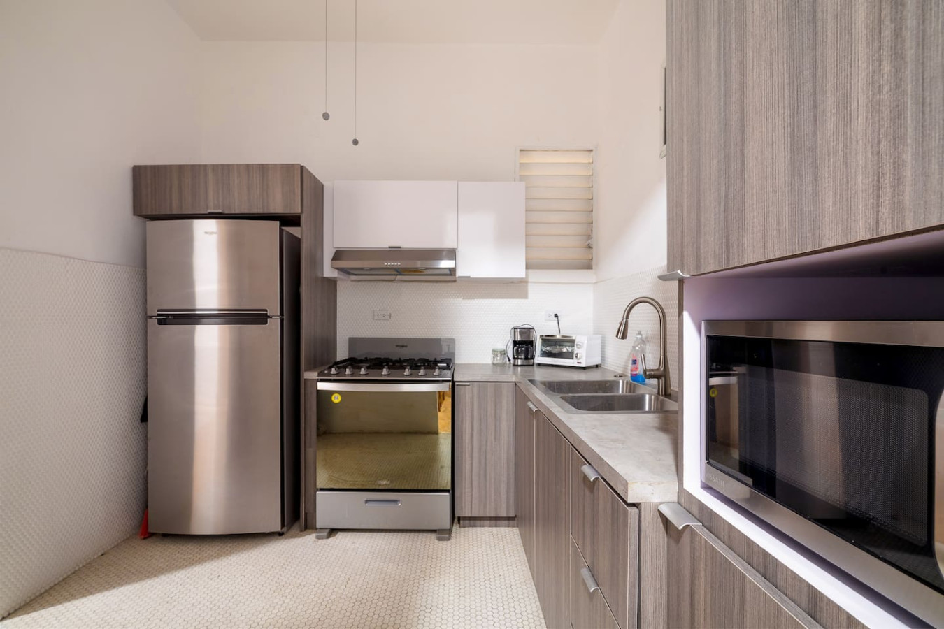Kitchen with a stainless fridge and a gas range — Luz Collection No.3 – Casa Horizonte | 3BR Loft, Santurce