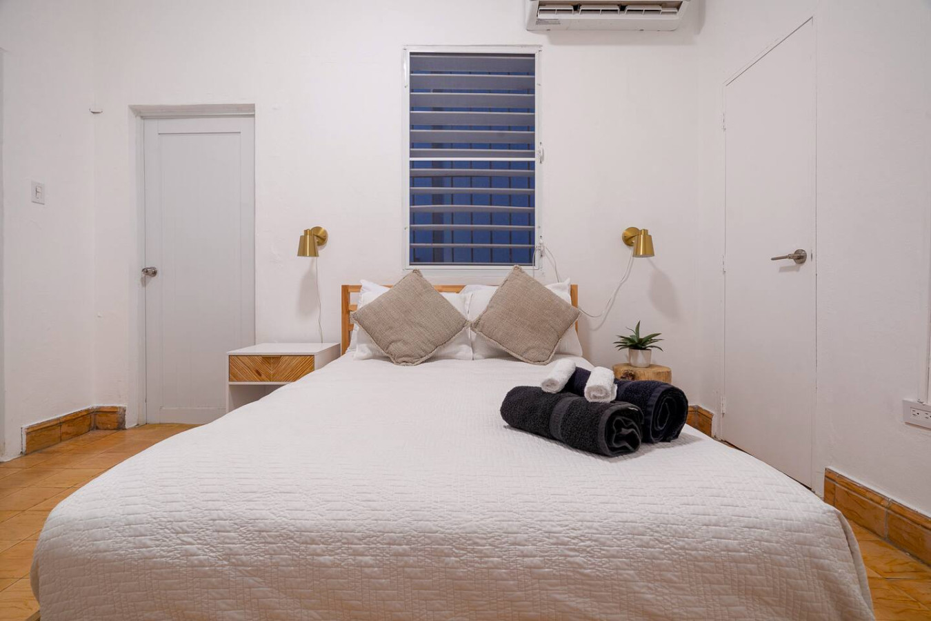 Bedroom with a white bed and two pillows — Luz Collection No.3 – Casa Horizonte | 3BR Loft, Santurce