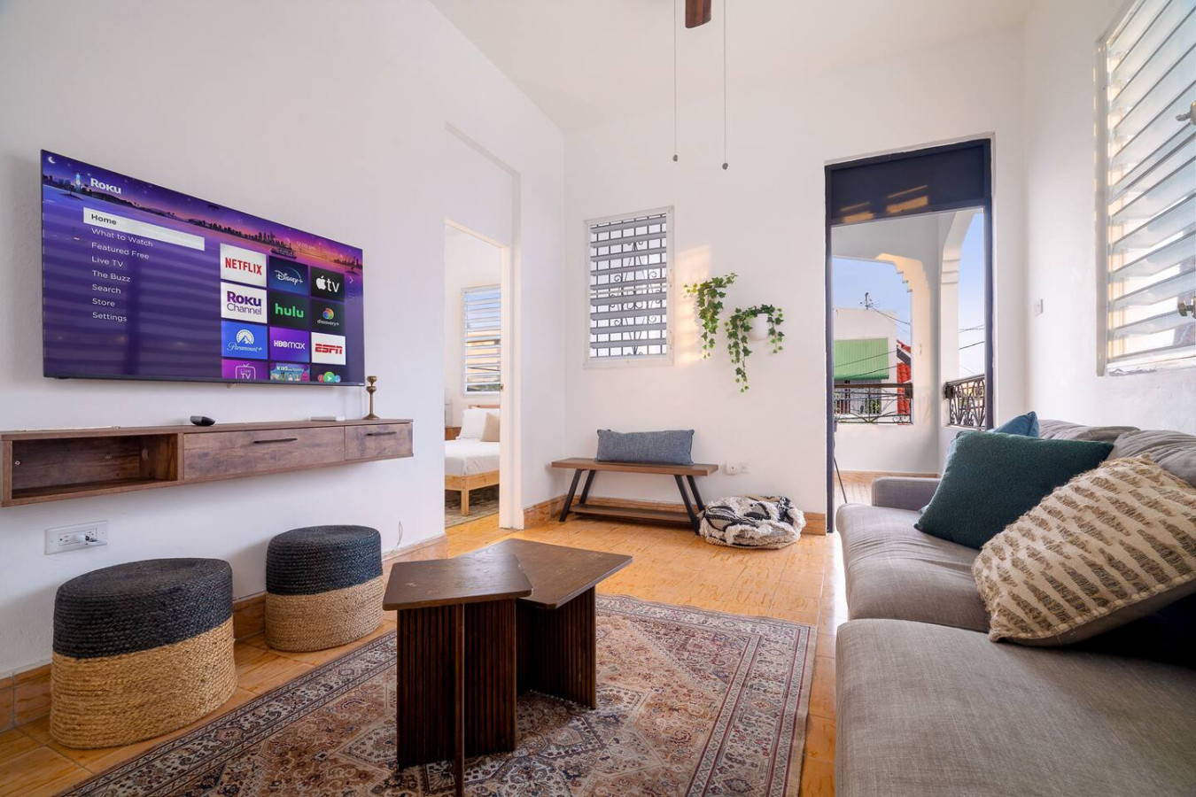 Living room with a flat screen TV and a couch — Luz Collection No.3 – Casa Horizonte | 3BR Loft, Santurce