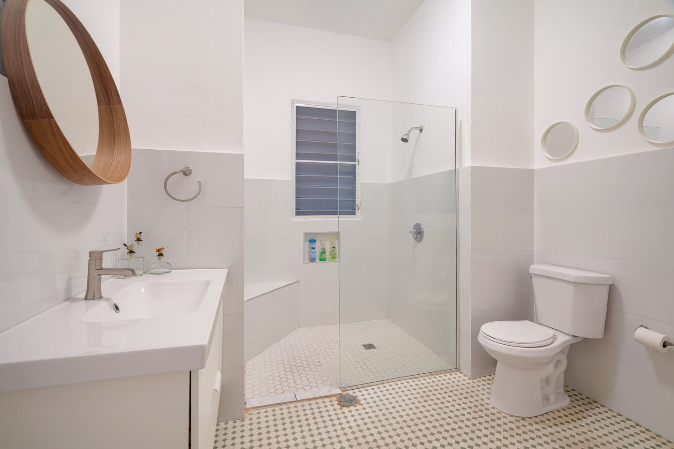 Bathroom with a white toilet and a shower with a glass door — Luz Collection No.3 – Casa Horizonte | 3BR Loft, Santurce