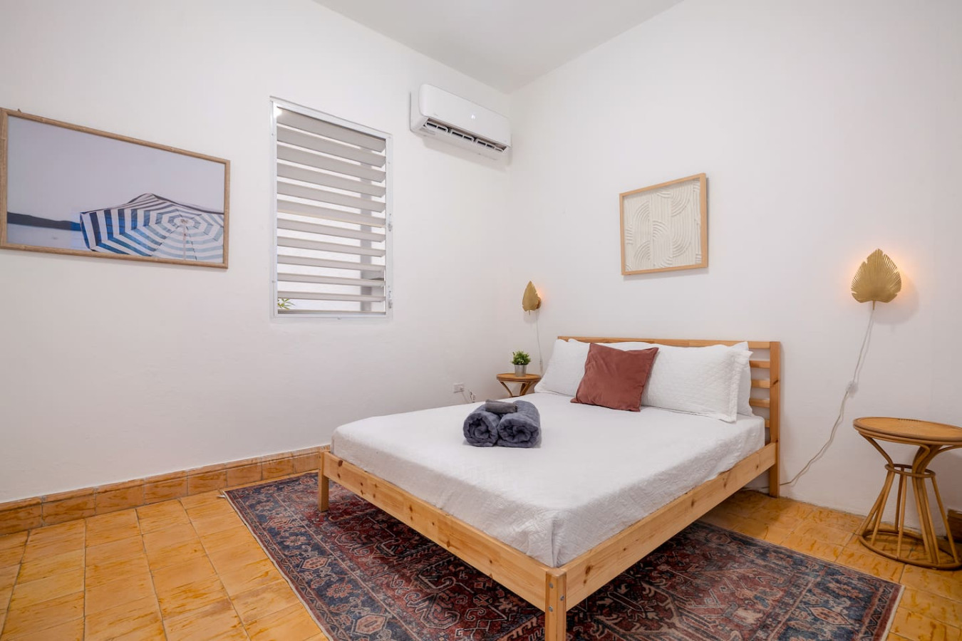 Bedroom with a bed, a nightstand, and a window with a view of — Luz Collection No.3 – Casa Horizonte | 3BR Loft, Santurce