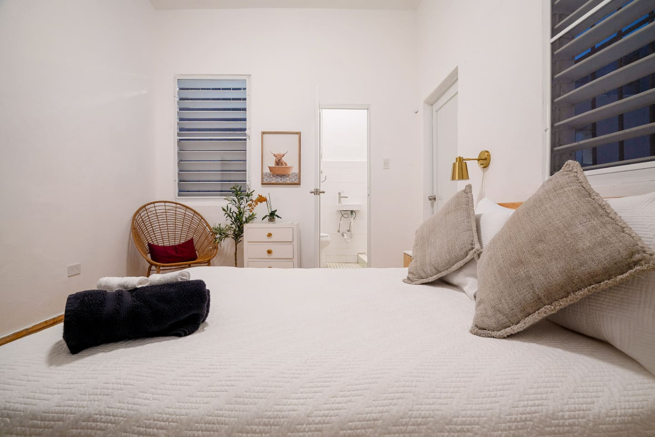 Bedroom with a white bedspread and pillows — Luz Collection No.3 – Casa Horizonte | 3BR Loft, Santurce