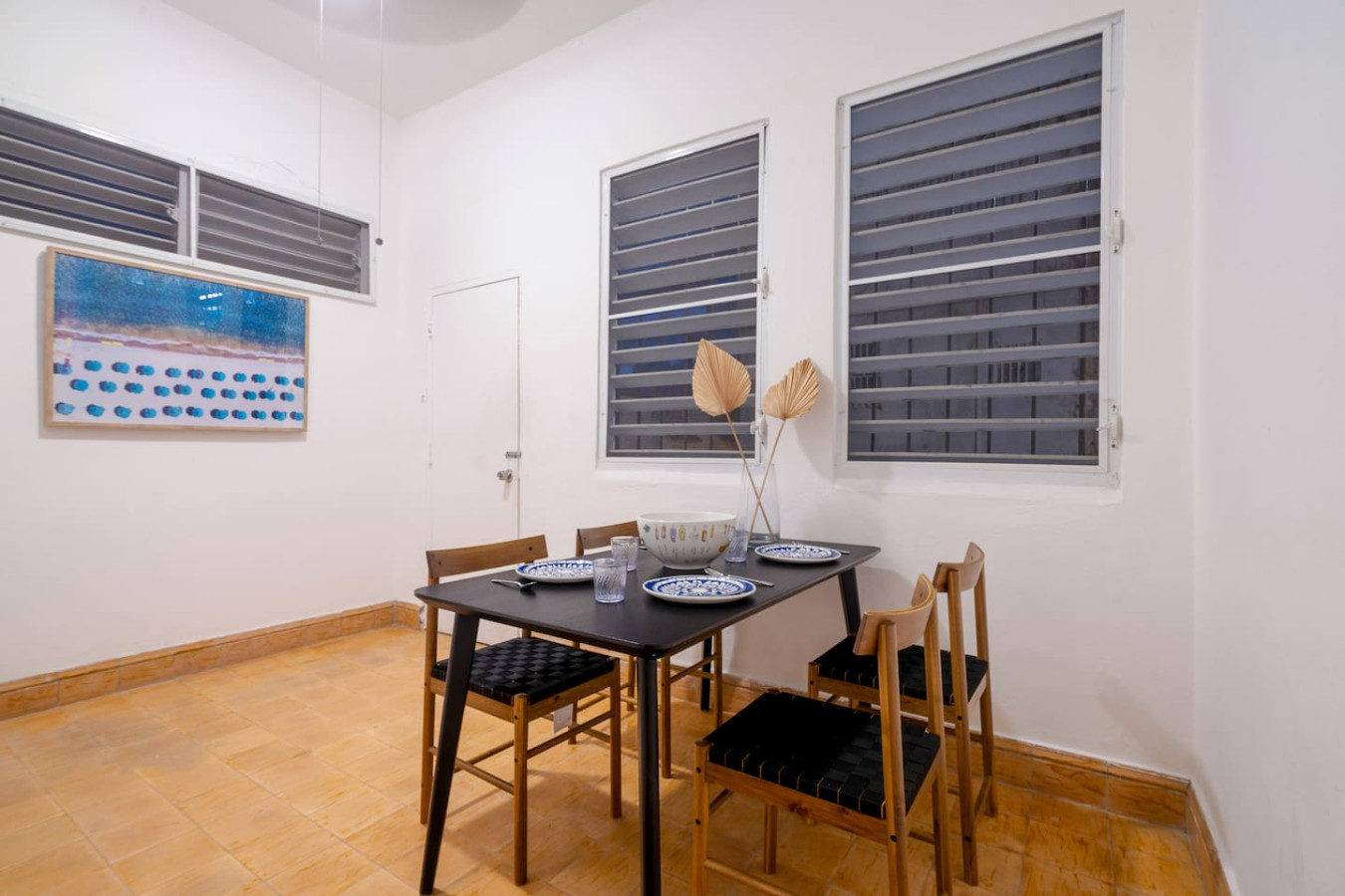 Black and white photo of a dining room table with chairs — Luz Collection No.3 – Casa Horizonte | 3BR Loft, Santurce