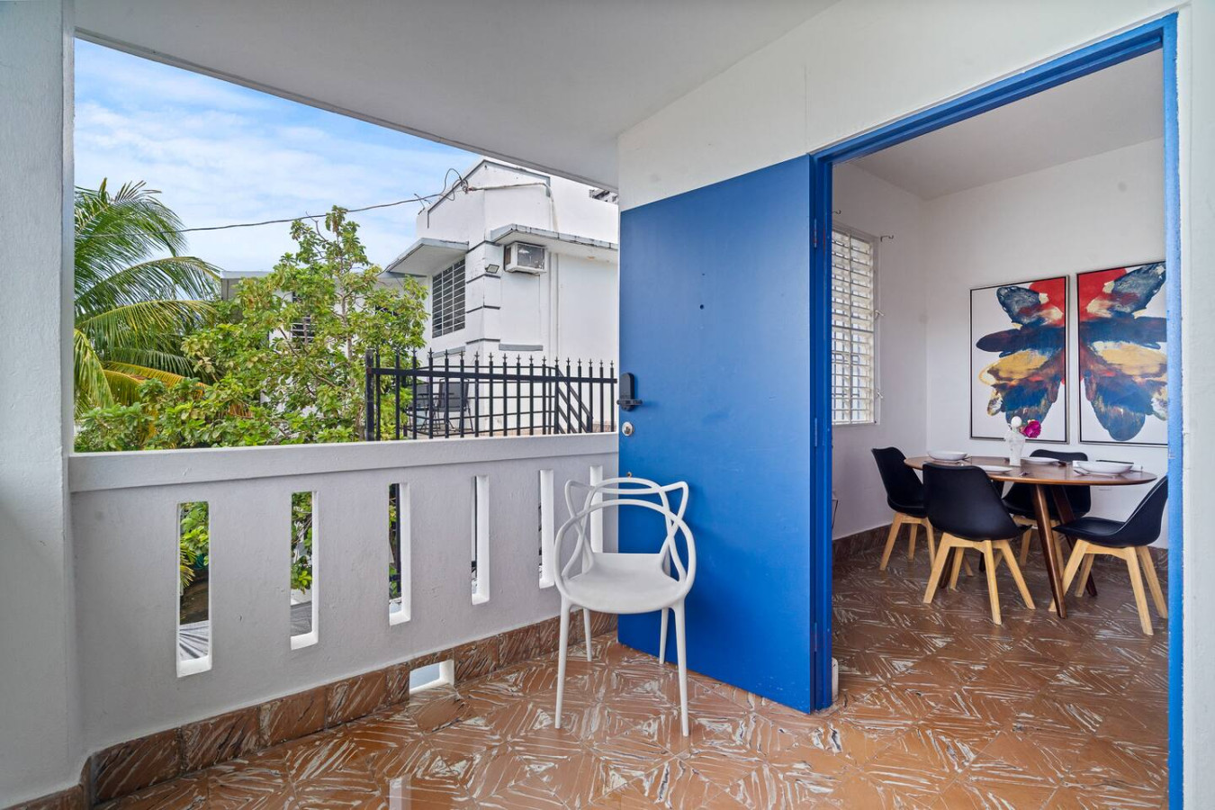 White chair on a balcony overlooking the ocean — Sunkiss in puerto Rico San Juan 3 Bedroom, Santurce