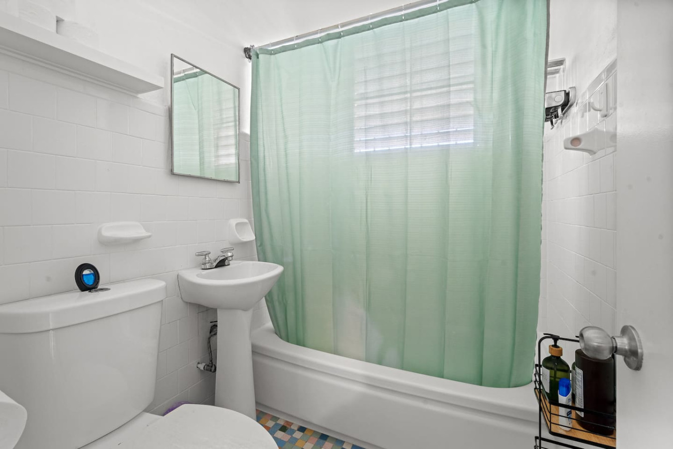 White toilet with a green shower curtain in a bathroom — Sunkiss in Puerto Rico San Juan 3 Bedroom, Santurce