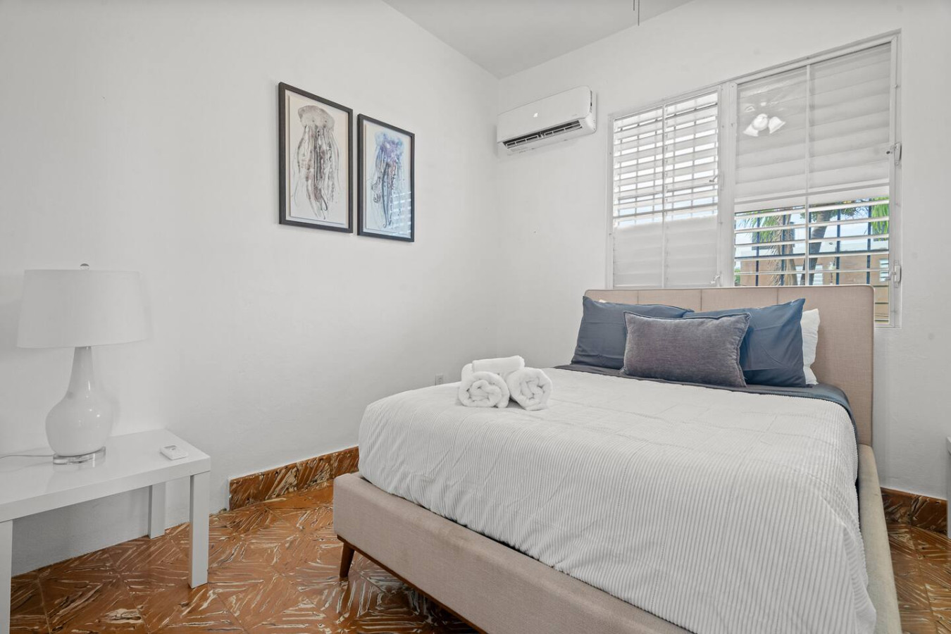 Bedroom with a bed, nightstand, and pictures on the wall — Sunkiss in puerto Rico San Juan 3 Bedroom, Santurce