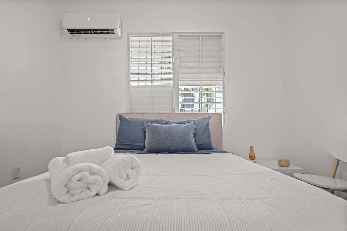 Bedroom with a white bed and two blue pillows — Sunkiss in puerto Rico San Juan 3 Bedroom, Santurce