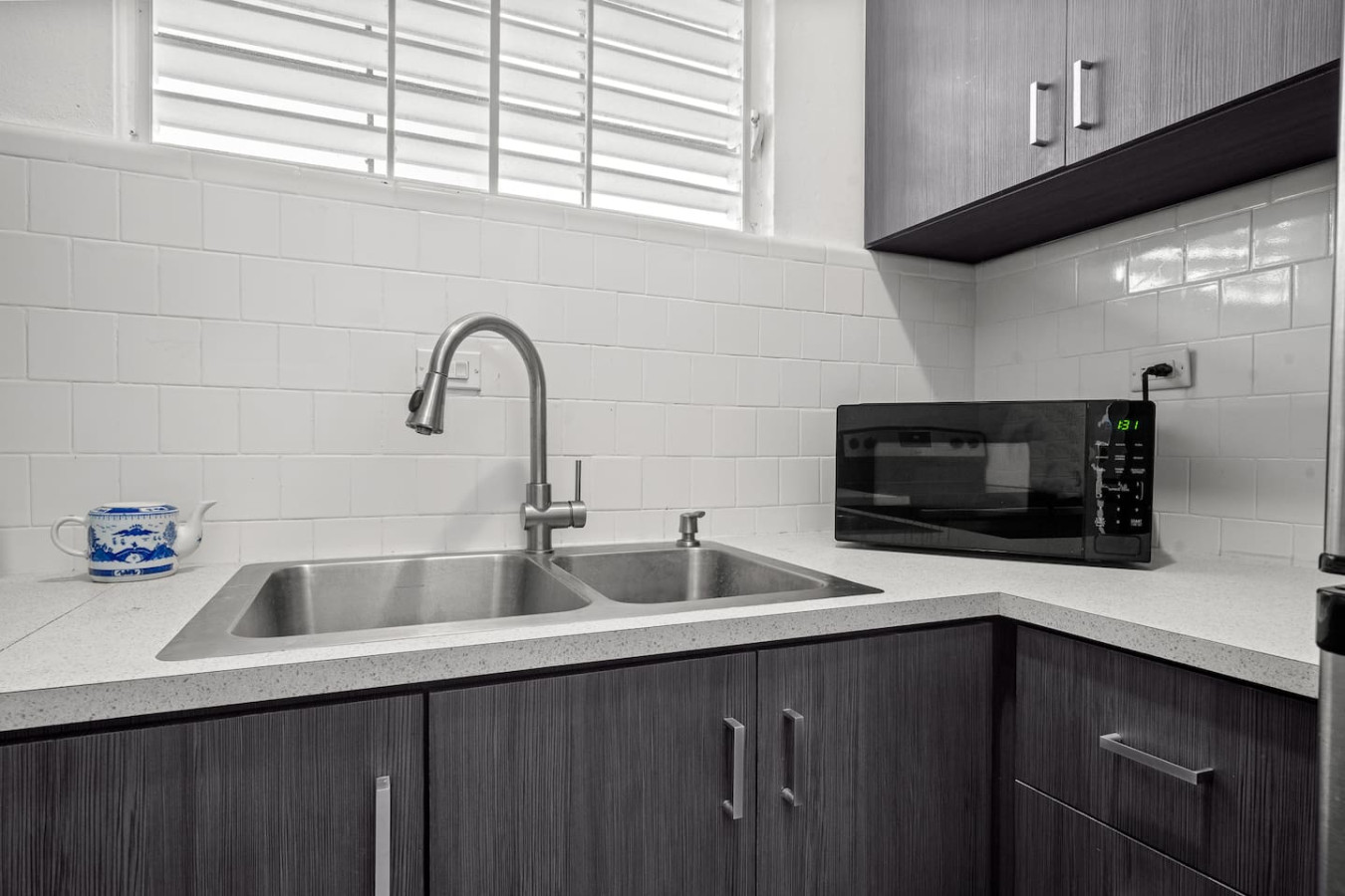 Kitchen with a double sink and a microwave — Sunkiss in Puerto Rico San Juan 3 Bedroom, Santurce