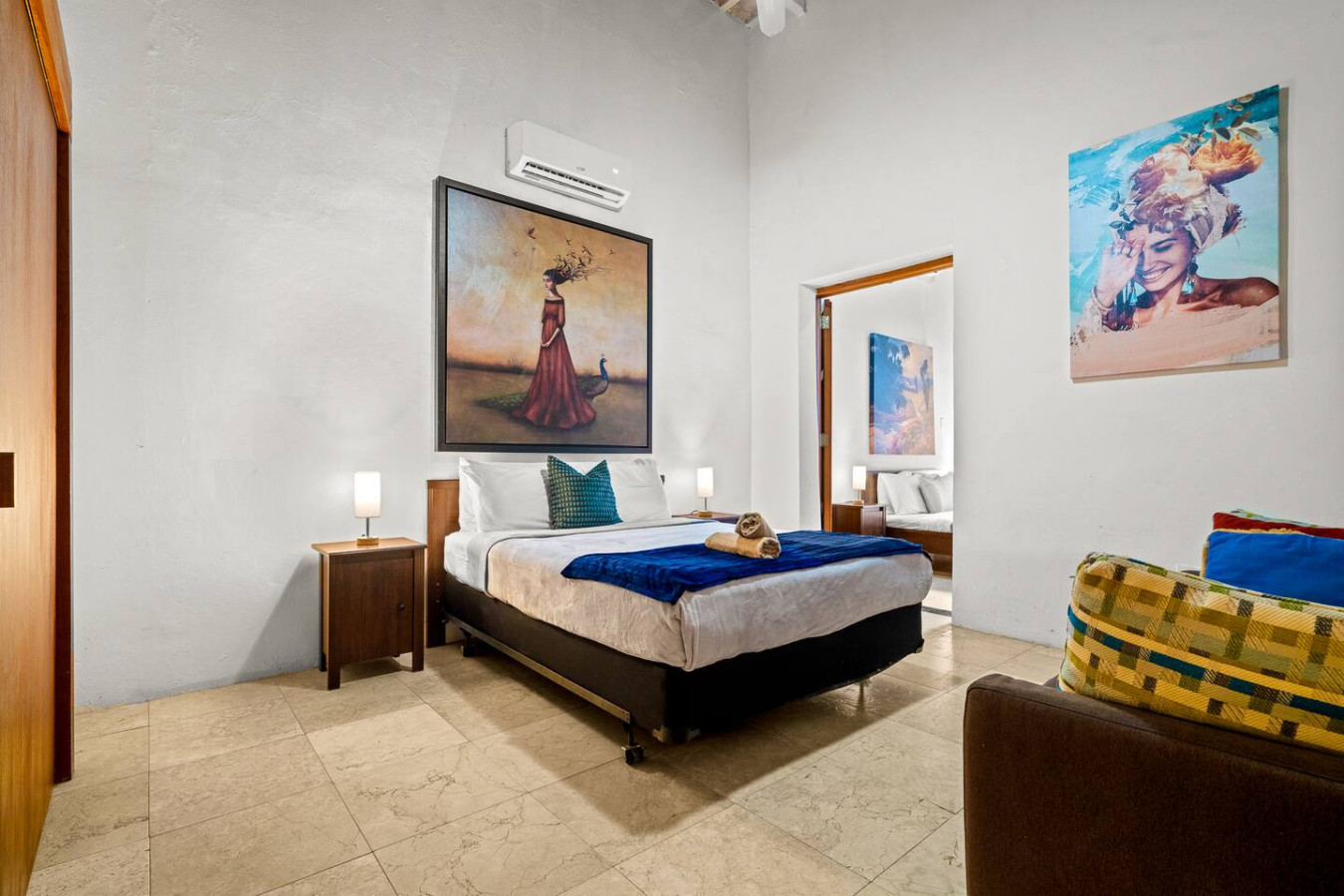 Bedroom with a bed, a painting on the wall, and a mirror on — Royal Imperial | Balcony Private | Old San Juan, Old San Juan