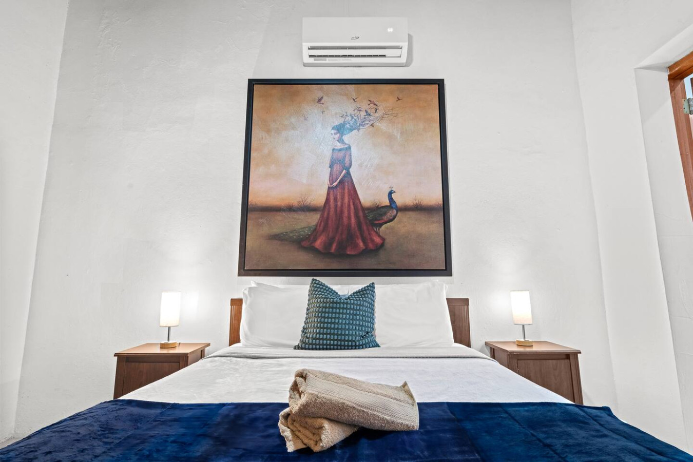 Bedroom with a painting on the wall and a bed with a blue — Royal Imperial | Balcony Private | Old San Juan, Old San Juan