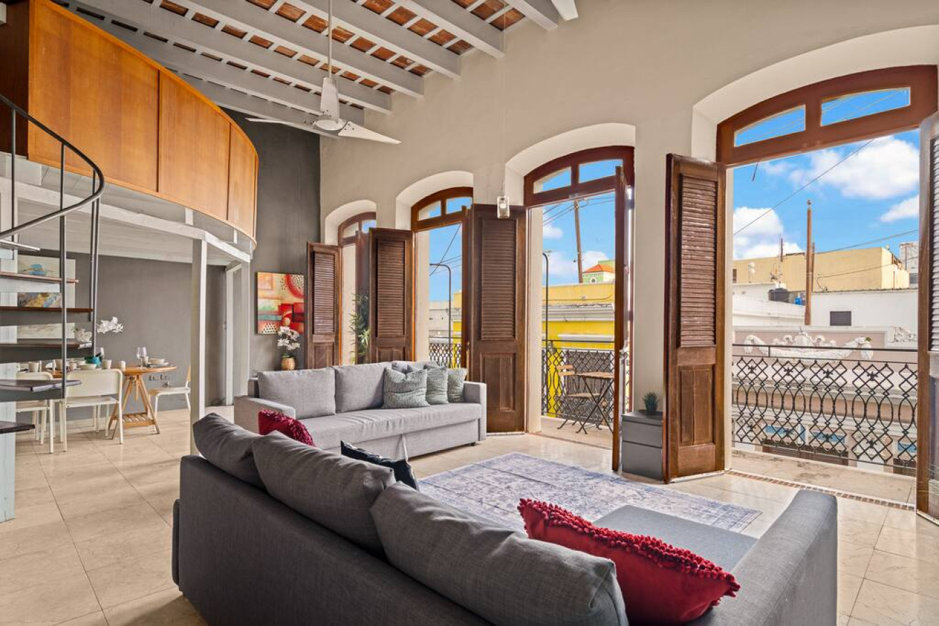 Living room with a couch and a large window — Royal Imperial | Balcony Private | Old San Juan, Old San Juan