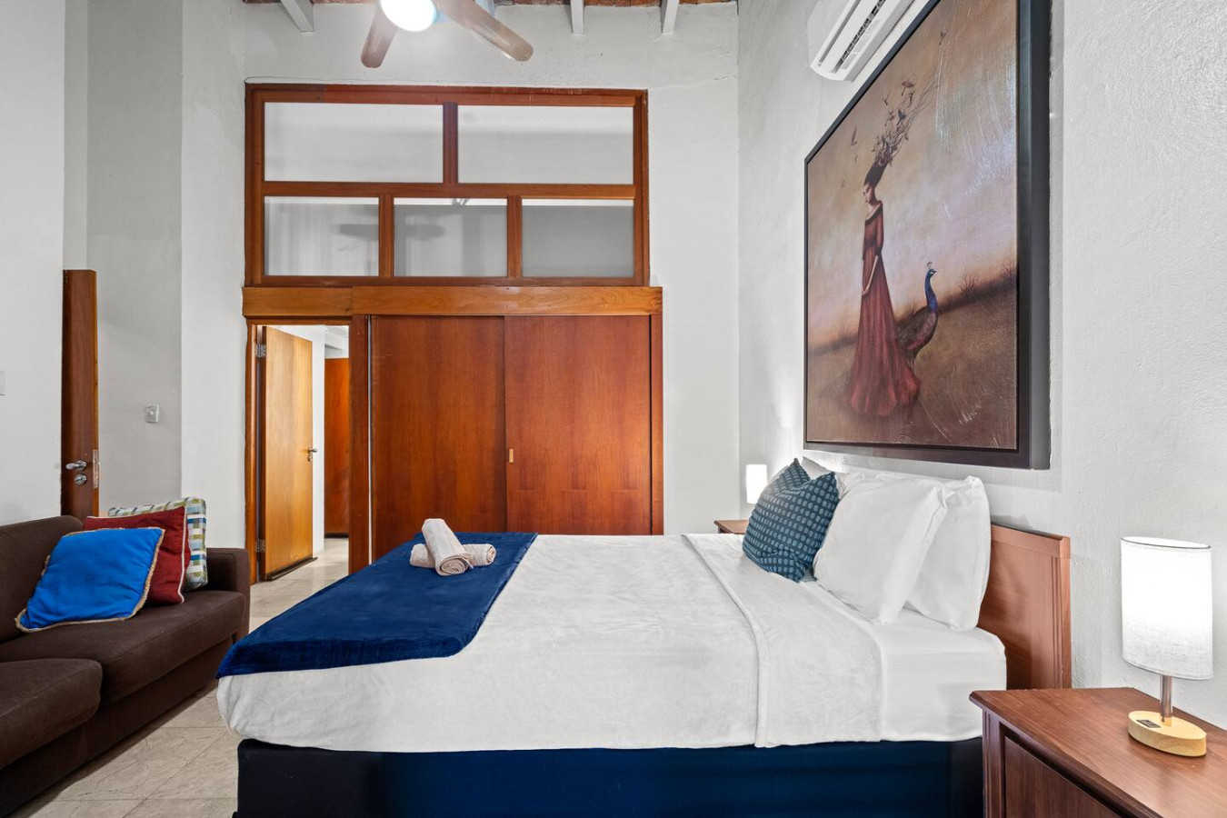 Bedroom with a large bed and a painting on the wall — Royal Imperial | Balcony Private | Old San Juan, Old San Juan