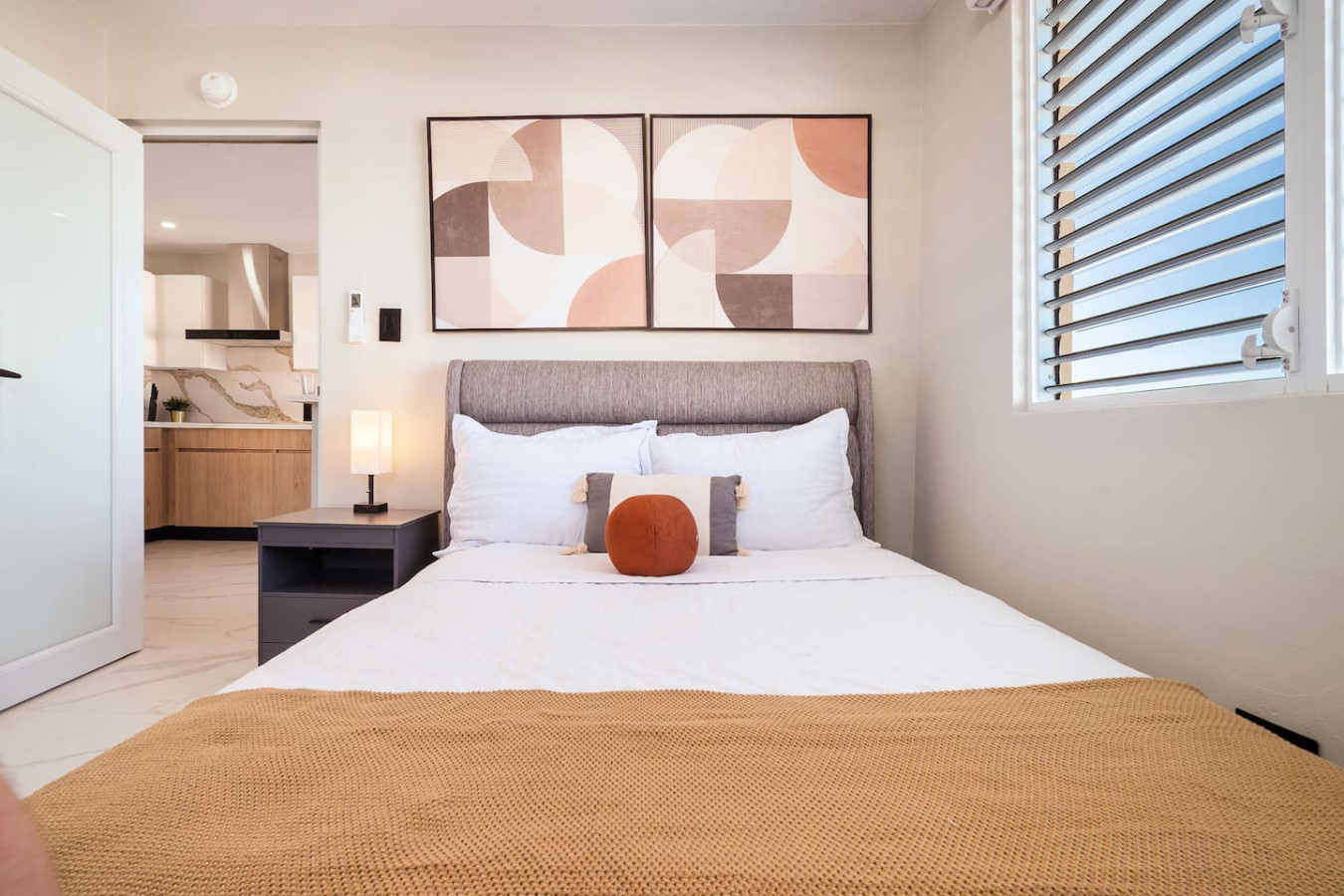 Bedroom with a bed and a lamp on a table — SunJoy Modern 2BR Apartment Isla Verde, Carolina