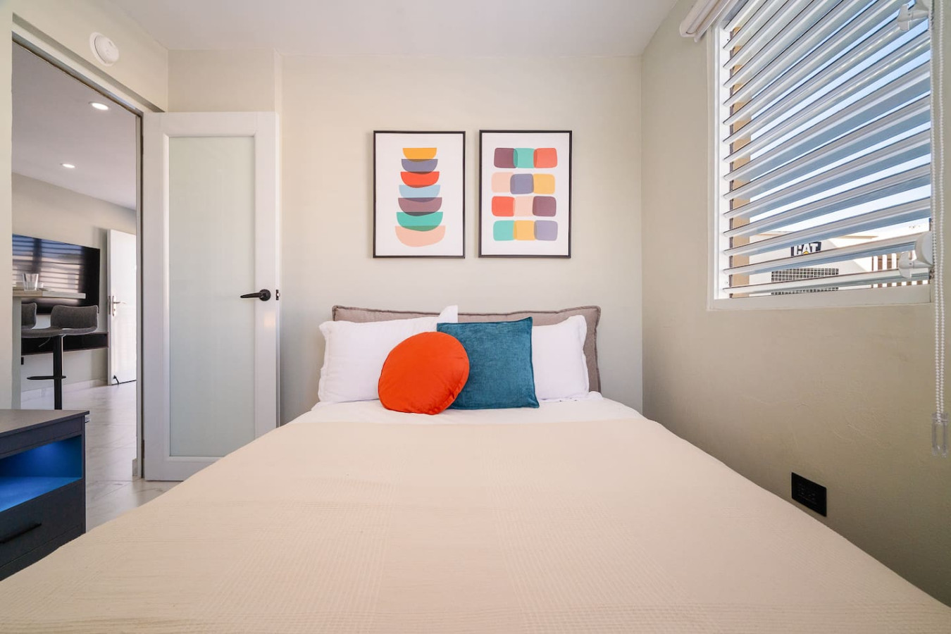 Bedroom with a white bedspread and a red pillow — SunJoy Modern 2BR Apartment Isla Verde, Carolina