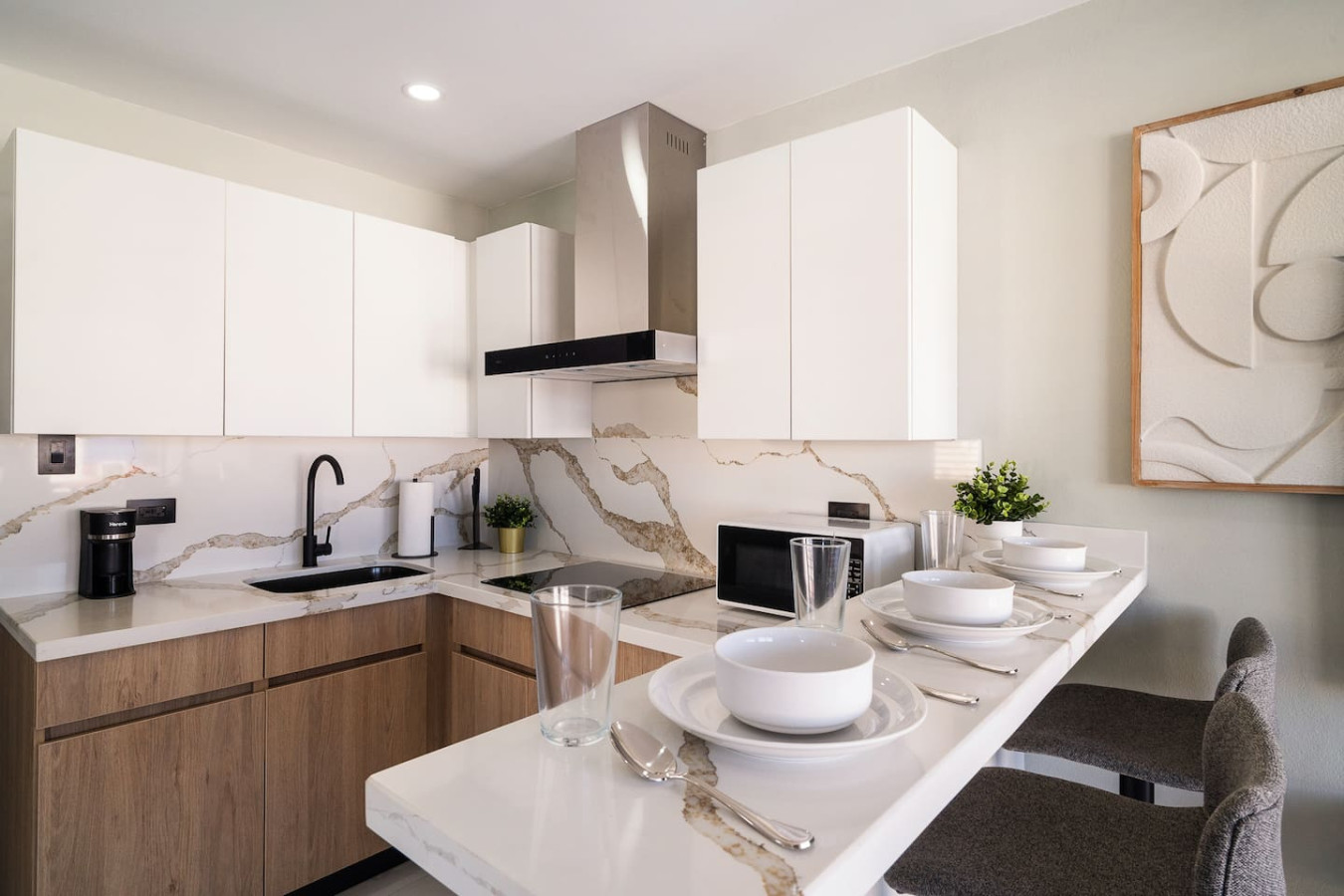 Kitchen with a black sink and a breakfast bar — SunJoy Modern 2BR Apartment Isla Verde, Carolina