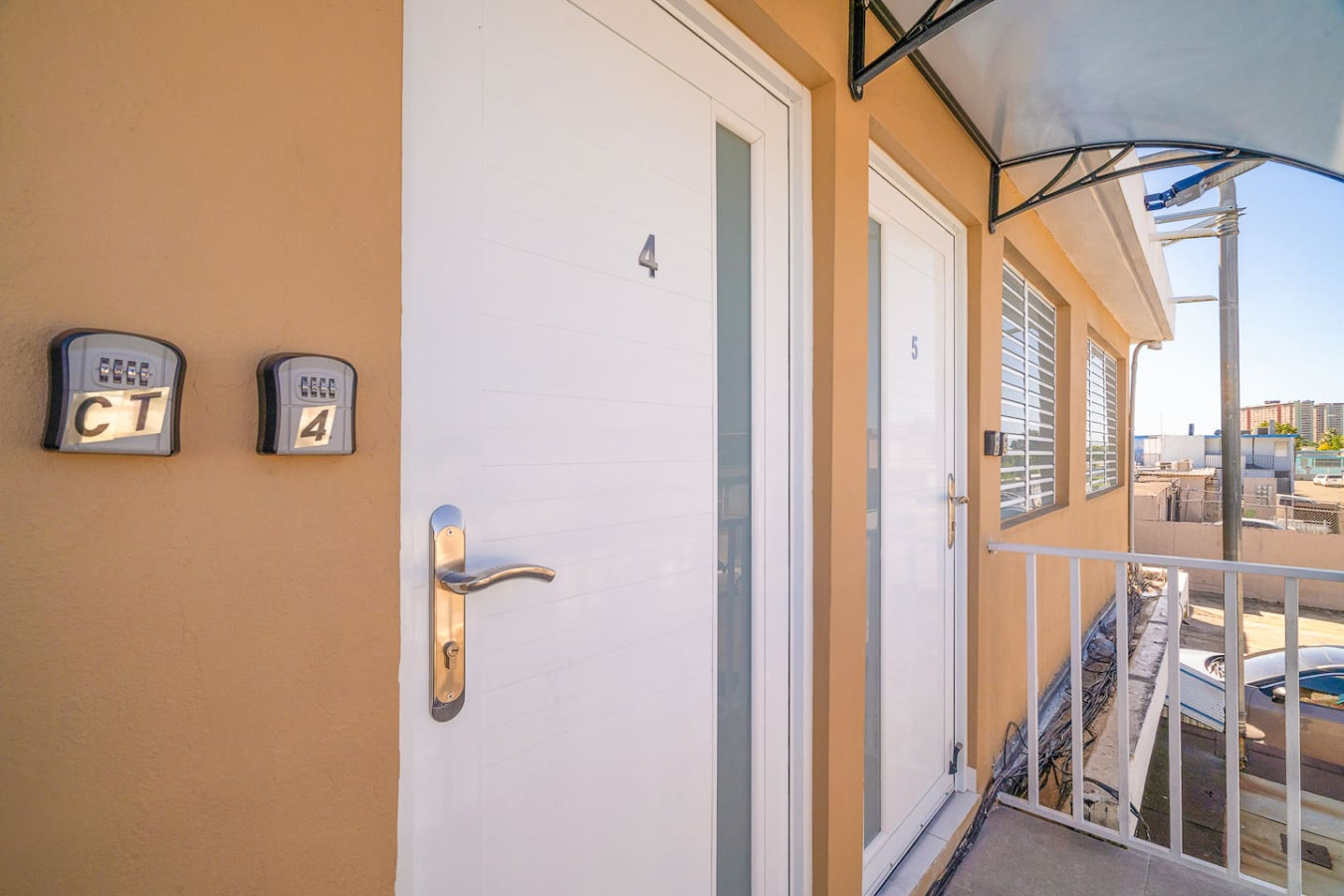 Front door of a house with a balcony — SunJoy Modern 2BR Apartment Isla Verde, Carolina