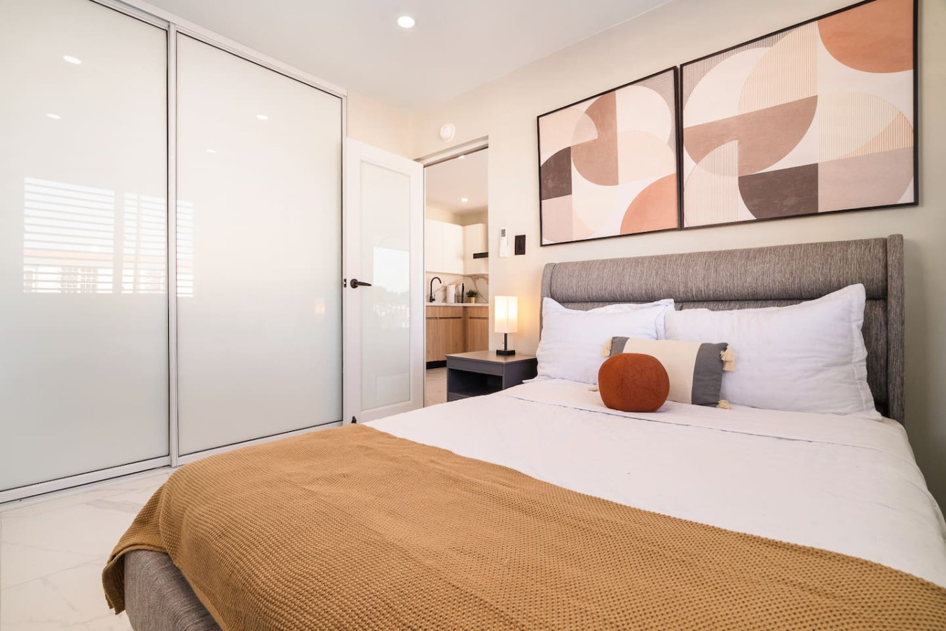 Bedroom with a bed and a lamp — SunJoy Modern 2BR Apartment Isla Verde, Carolina