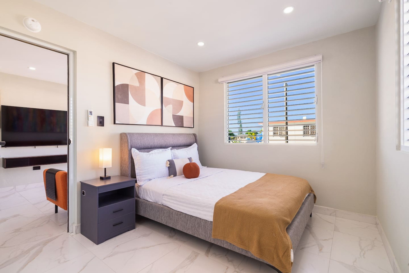 Bedroom with a bed, nightstand, and a painting on the wall — SunJoy Modern 2BR Apartment Isla Verde, Carolina