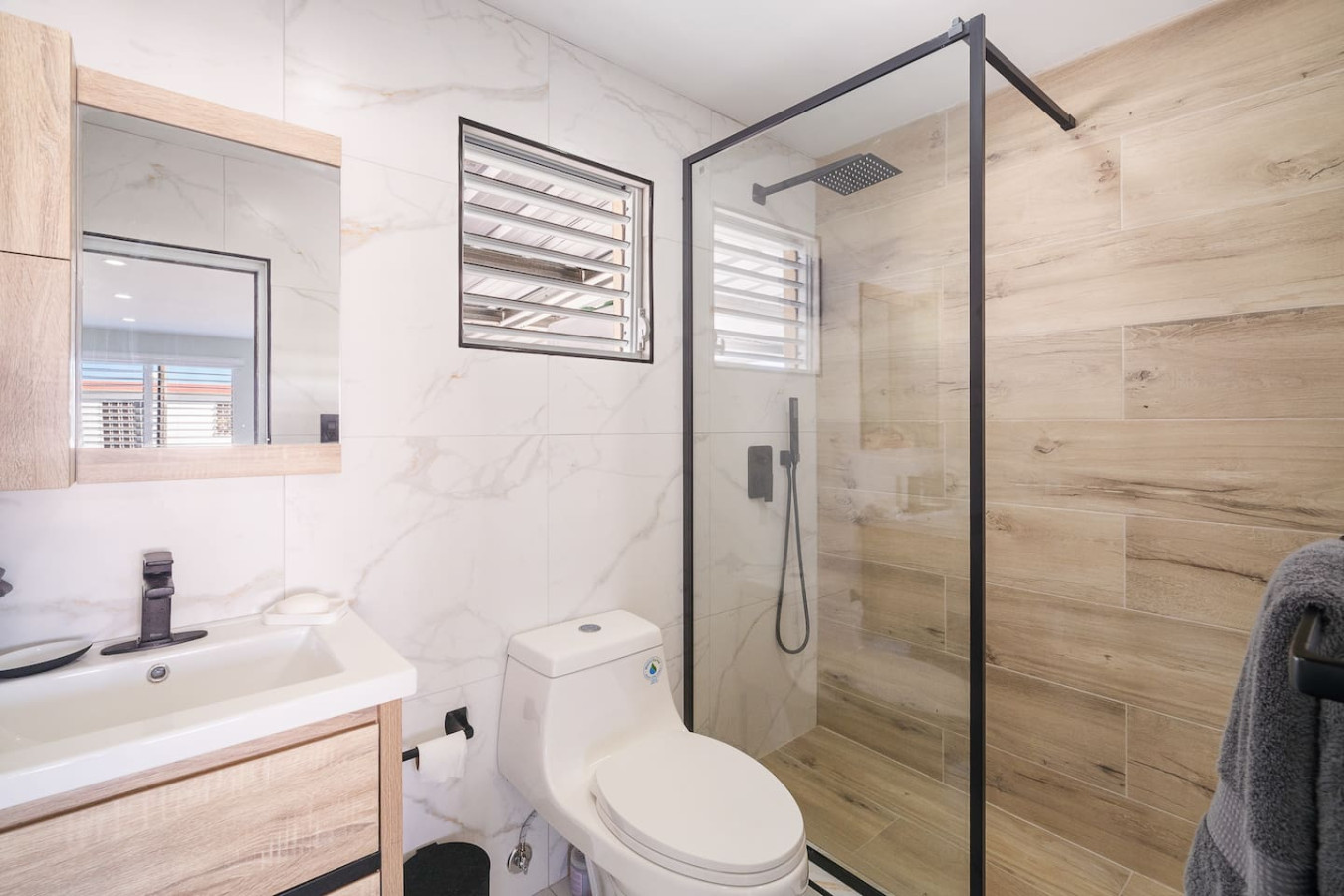 White toilet in a bathroom — SunJoy Modern 2BR Apartment Isla Verde, Carolina