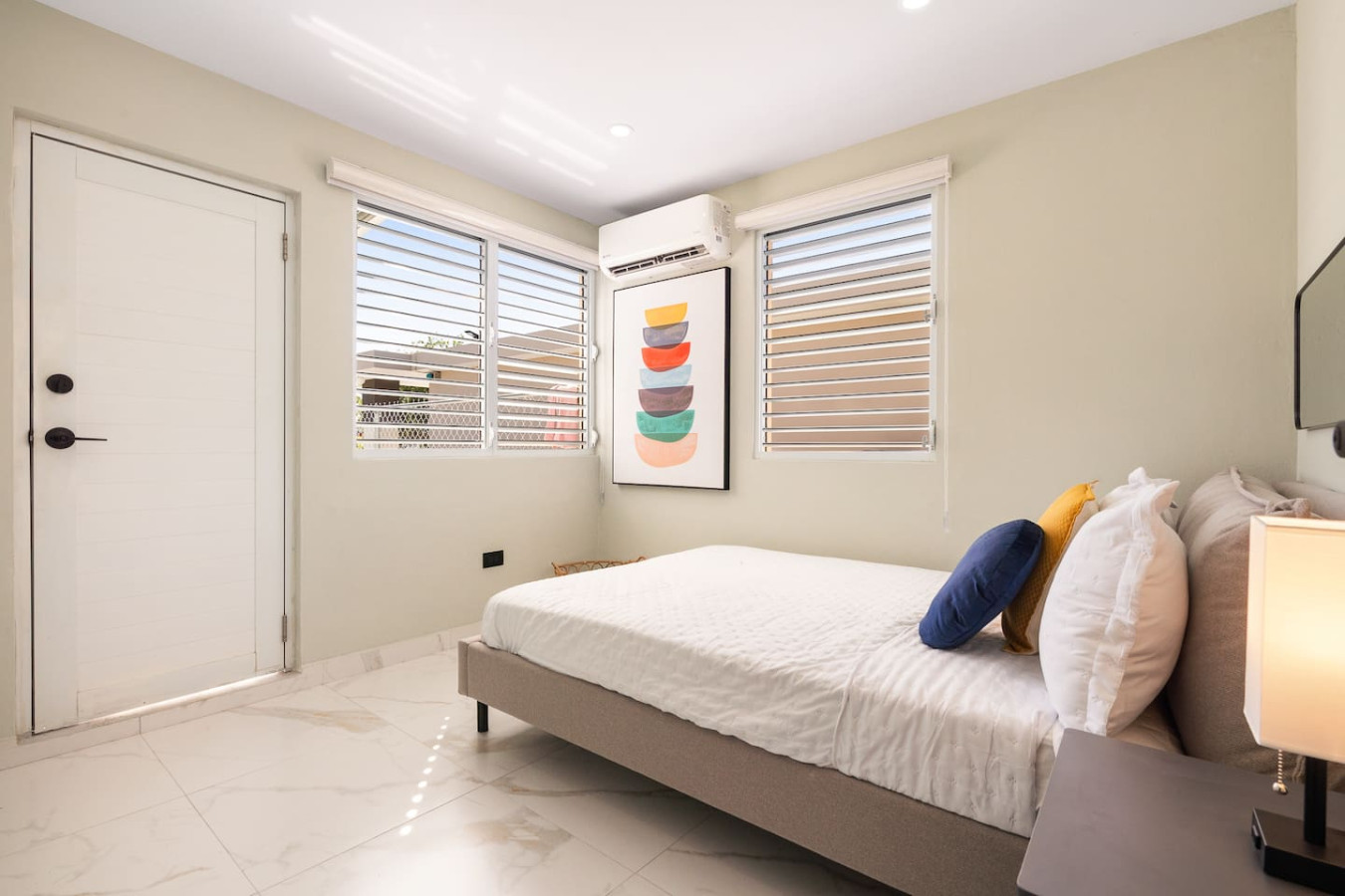 Bedroom with a bed and a painting on the wall (bedroom 2) — MoonJoy Chic 2BR Apartment Private Patio, Carolina