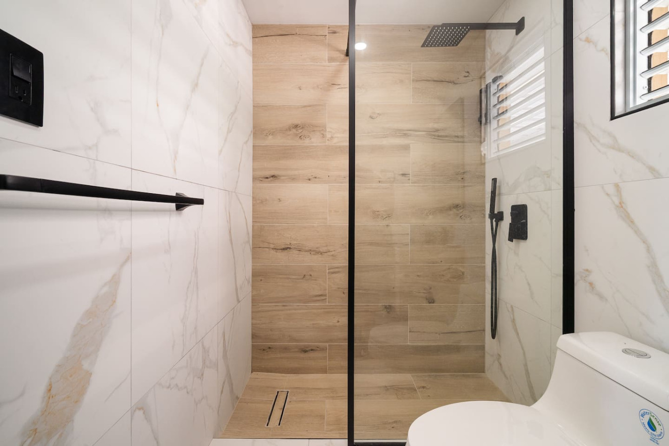 Walk-in shower with wood-look tile and a rain head — MoonJoy Chic 2BR Apartment Private Patio, Carolina