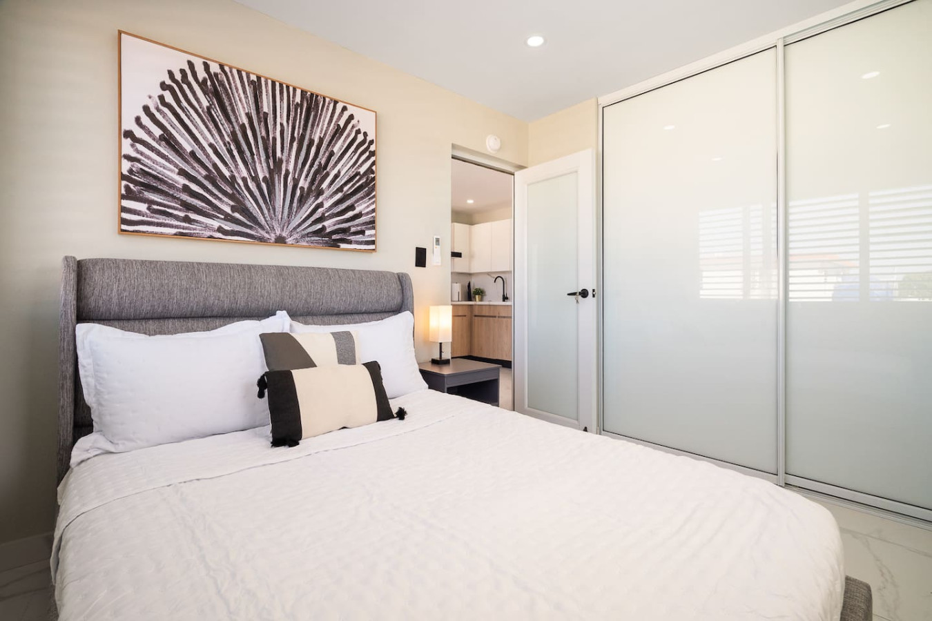 Bedroom with a bed and a painting on the wall — MoonJoy Chic 2BR Apartment Private Patio, Carolina