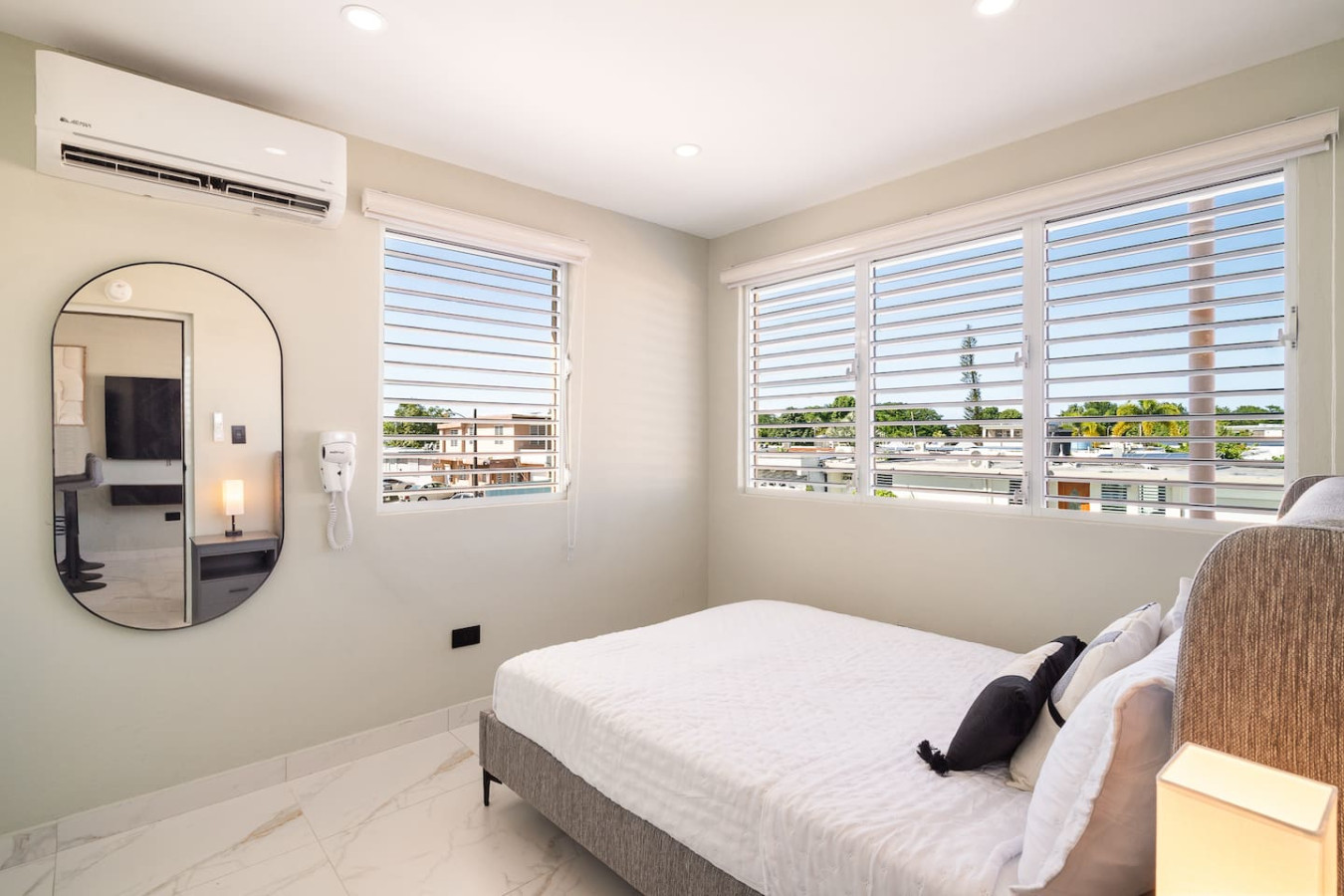 Bedroom with a bed and a cat on the bed — MoonJoy Chic 2BR Apartment Private Patio, Carolina