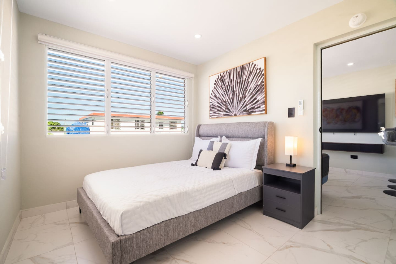 Bedroom with a large bed and a view of the ocean — MoonJoy Chic 2BR Apartment Private Patio, Carolina