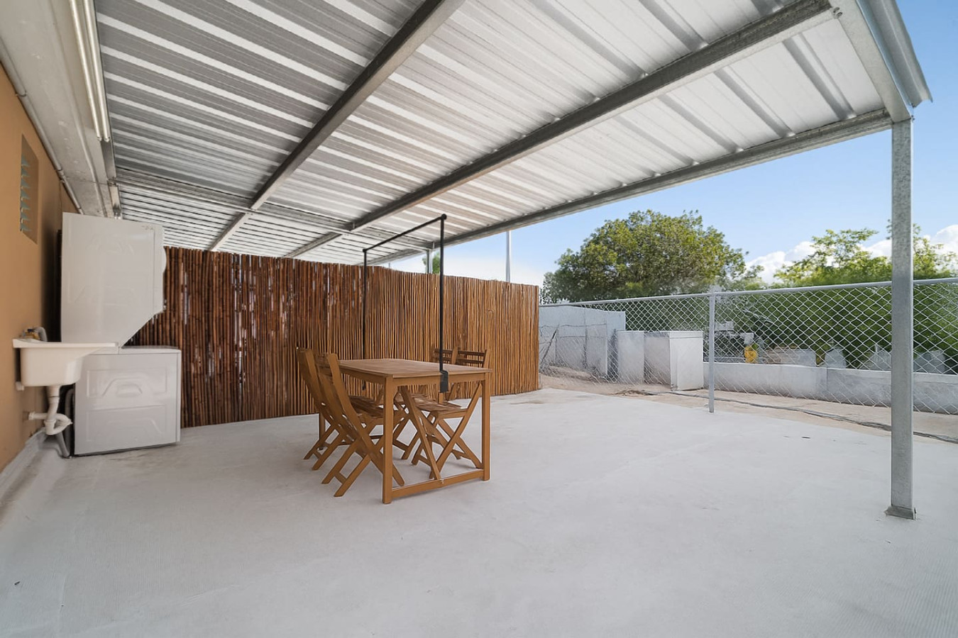 Wooden table and chairs on a patio — MoonJoy Chic 2BR Apartment Private Patio, Carolina