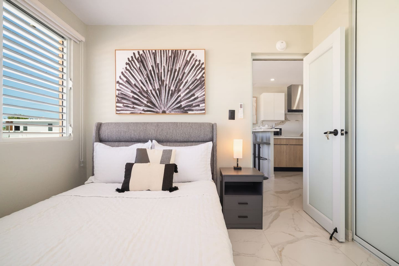 Bedroom with a bed, nightstand, and lamp — MoonJoy Chic 2BR Apartment Private Patio, Carolina