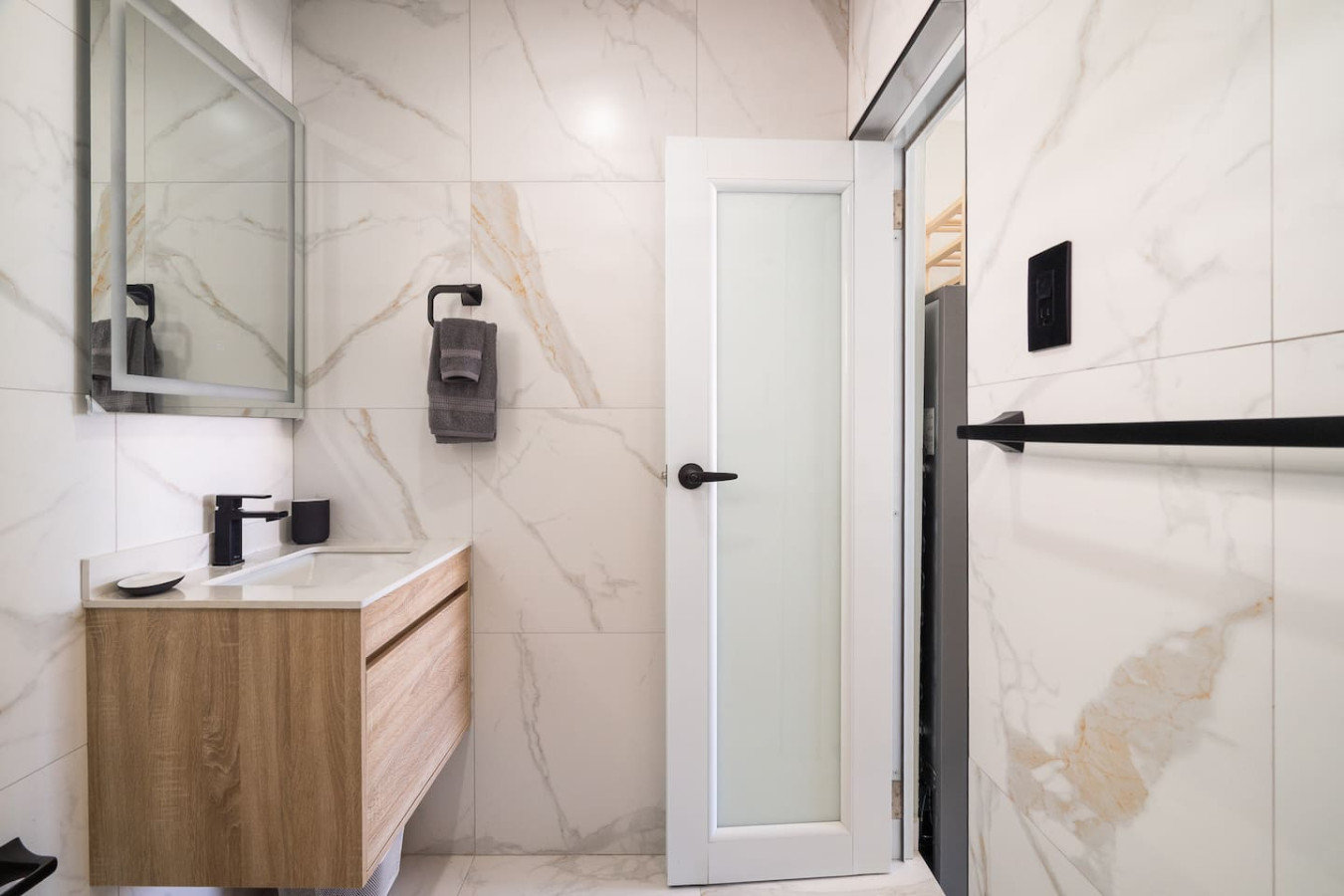 Bathroom vanity beside a frosted glass door — MoonJoy Chic 2BR Apartment Private Patio, Carolina