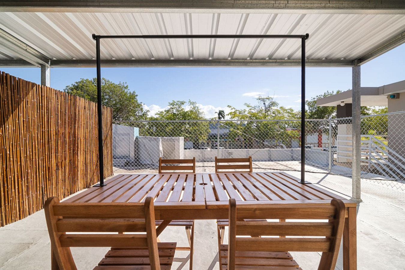 Wooden patio table with chairs outside a house — MoonJoy Chic 2BR Apartment Private Patio, Carolina