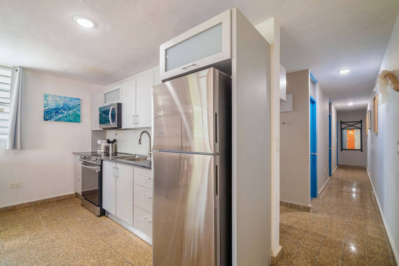 Kitchen with a steel fridge beside the hallway — Walking to the Beach 3 bedroom House Next to Ocean, Luquillo