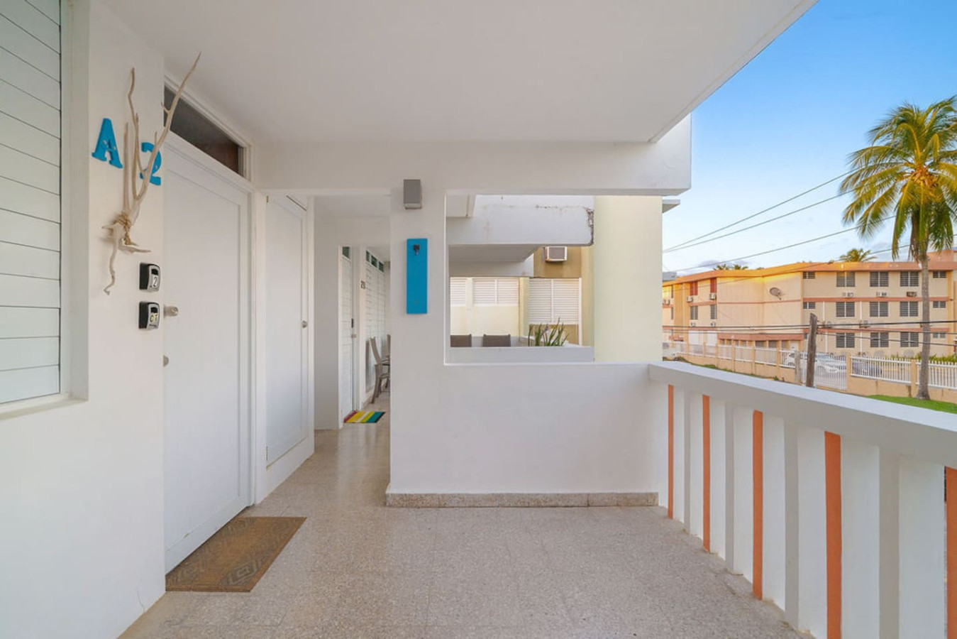 White house with a blue door and a balcony — Walking to the Beach 3 bedroom House Next to Ocean, Luquillo