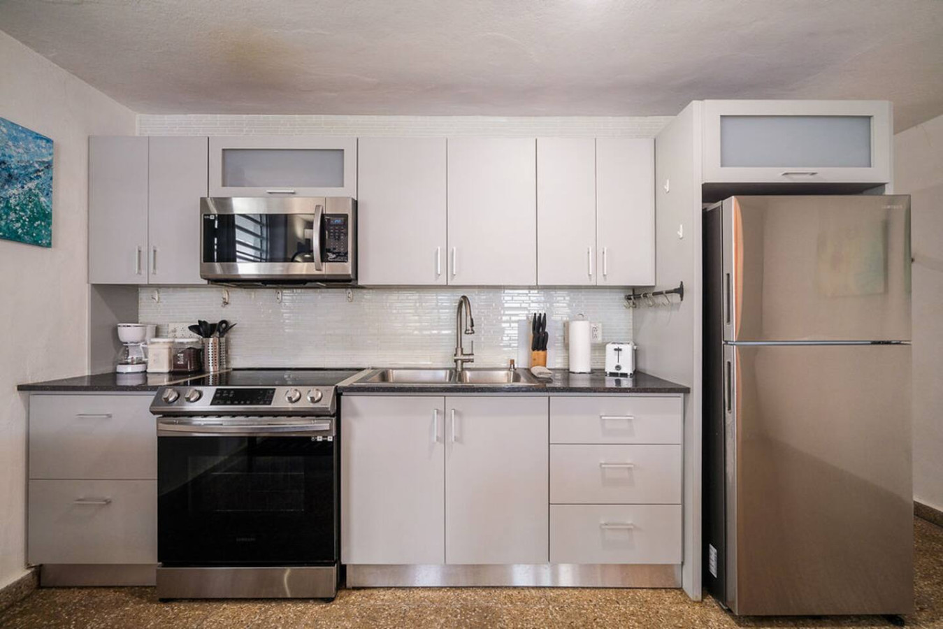 Kitchen with a stove, oven, microwave, and sink — Walking to the Beach 3 bedroom House Next to Ocean, Luquillo