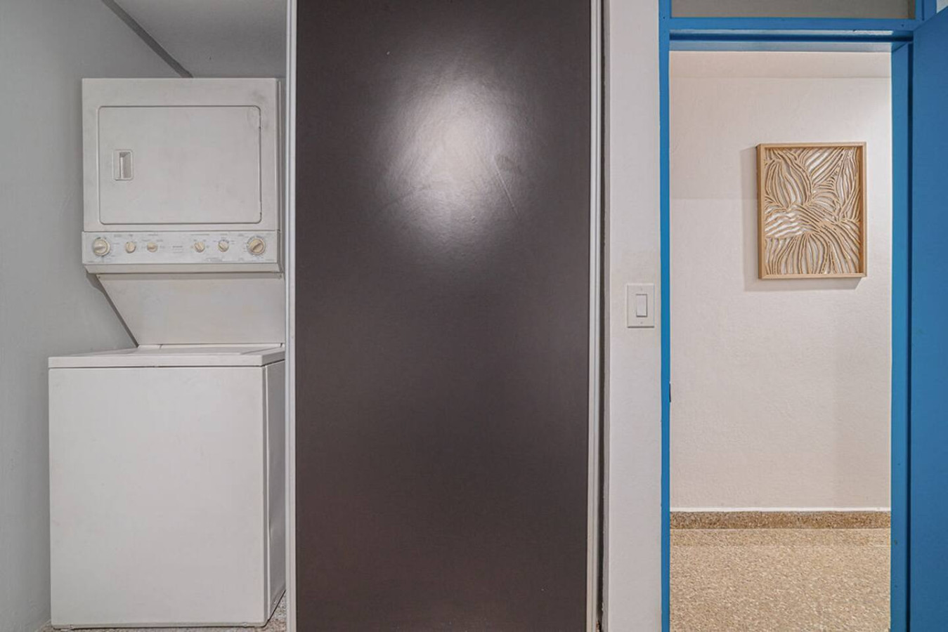 Laundry closet with a stacked washer and dryer — Walking to the Beach 3 bedroom House Next to Ocean, Luquillo