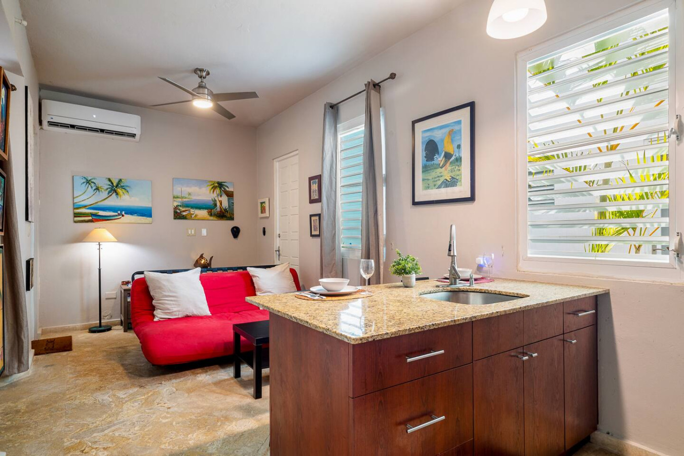 Kitchen with a sink and a red couch in the background — Historical Old SanJuan Spanish style private Patio, San Juan