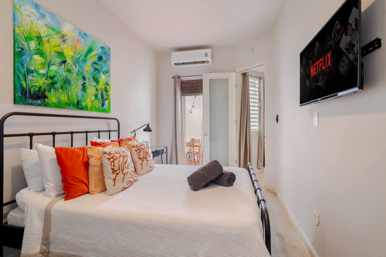 Bedroom with a bed, pillows, and a window air conditioner — Historical Old SanJuan Spanish style private Patio, San Juan