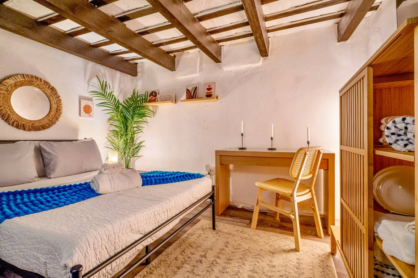 Bedroom with a bed, a chair, and a potted plant — La Cueva Loft Rustic Colonial Romance, Old San Juan